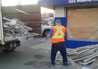 Mitten loading truck at job site